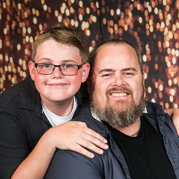 father son dad love parenting portrait at school for grad night