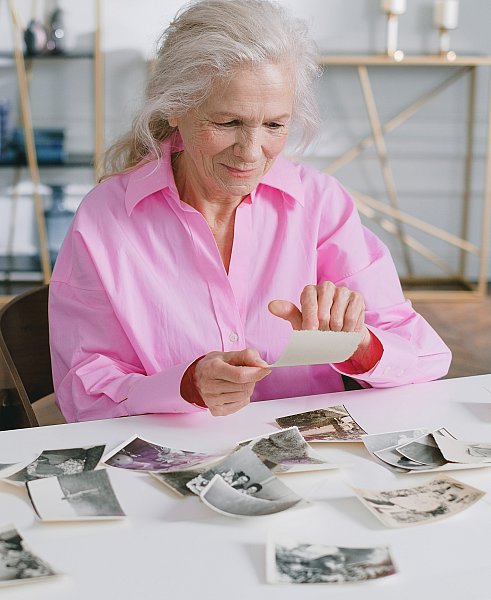 grandmother looking at her past with old photographs